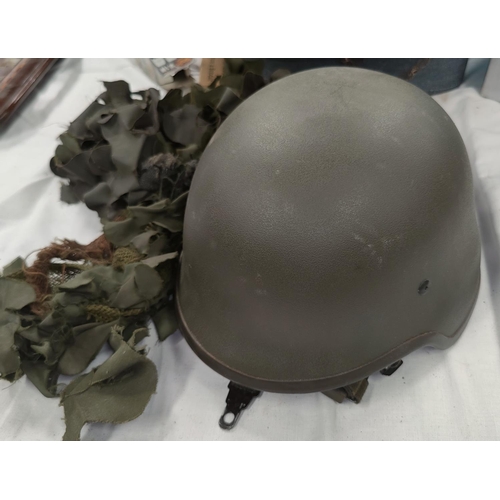 162 - A modern combat composition helmet and camouflage cover.