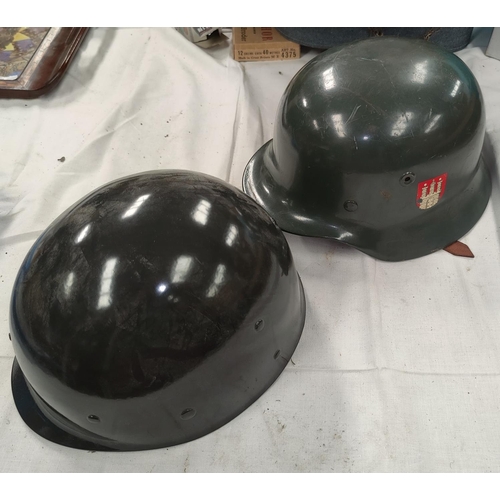 163 - A German style steel helmet, leather lining and a plastic helmet.