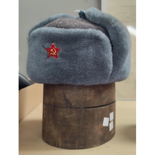 171 - A Russian Soviet era, lined wool hat with enamel badge and an old pine hat mould.