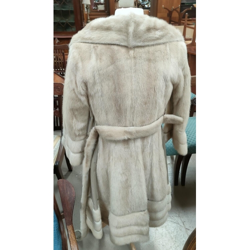 42E - A modern full length pale mink coat with beige leather trim to front, sleeves and hemline, horizonal... 