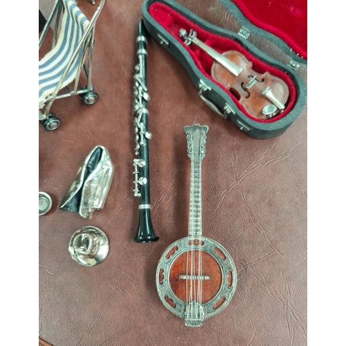 62A - A small selection of silver mounted miniature instruments, violin, Banjo and Trumpet, stamped 925 an... 