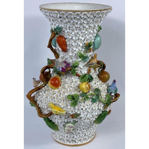 436A - A continental heavily encrusted vase, woven with branches and vines decorated with fruit and birds i... 