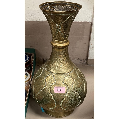 386 - A 19th century middle eastern brass vase with relief decoration and script 43cm
Good condition wear ... 