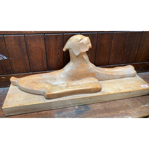 647C - Finland 20th Century:  carved wood figure of a recumbent sphinx, indistinctly signed to the plinth, ... 