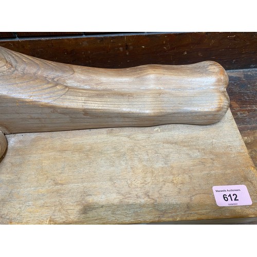 647C - Finland 20th Century:  carved wood figure of a recumbent sphinx, indistinctly signed to the plinth, ... 
