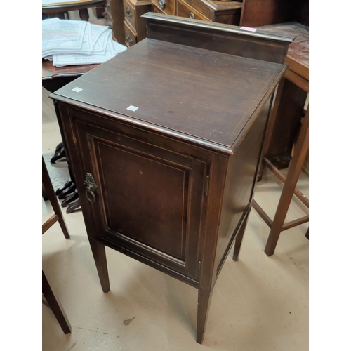 815 - An Edwardian mahogany ledgeback bedside cupboard, inlaid stringing decoration