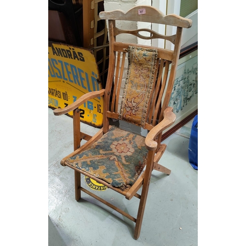 837 - An Art Noveau folding chair with tapestry seat and back; an oak hall chair