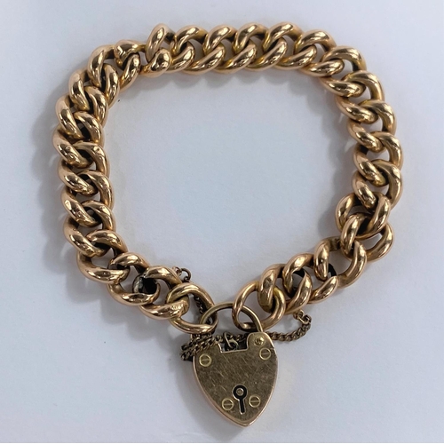 633 - A large link curb chain bracelet, stamped '15c', with heart lock, stamped '15c', 19.9 gm (one link s... 
