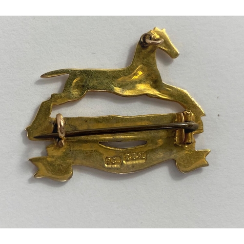 635 - A yellow metal and enamel military badge 
