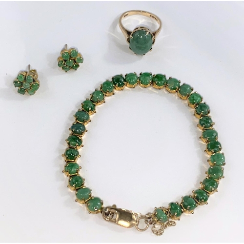 690 - A suite of jewellery, set with cabochon cut green stones, comprising of: bracelet with clasp stamped... 