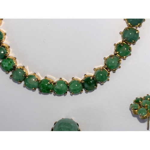 690 - A suite of jewellery, set with cabochon cut green stones, comprising of: bracelet with clasp stamped... 