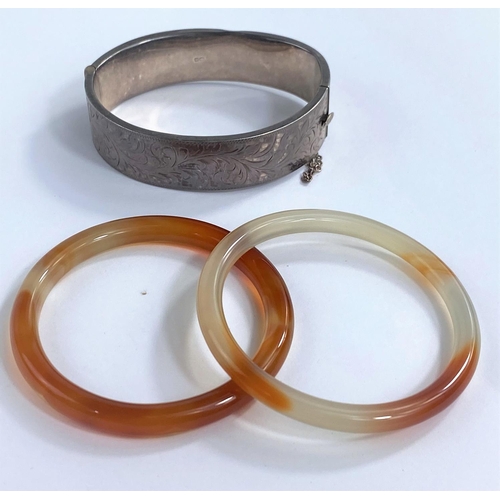 692 - 2 white/amber coloured hardstone bangles; a hallmarked silver bracelet

NO BIDS SOLD WITH NEXT LOT
