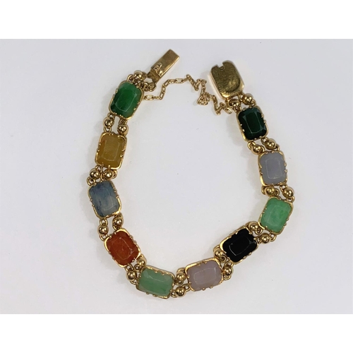 696 - A yellow metal bracelet set with multicloured stones, unmarked (tests as circa 18ct.)