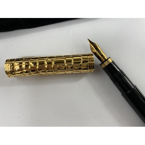 131 - A boxed Versace fountain pen made by Omas with 
gilt crocodile skin effect highlights on lid and end... 