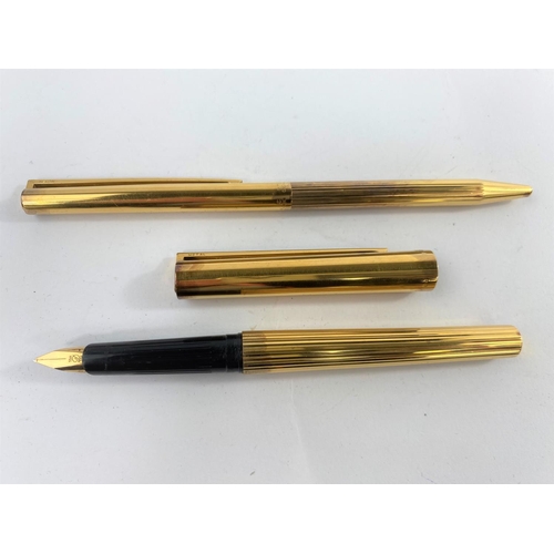 132 - A vintage S.T. Dupont silver gilt fountain pen and ball 
point with 18ct gold nib red and blue colou... 