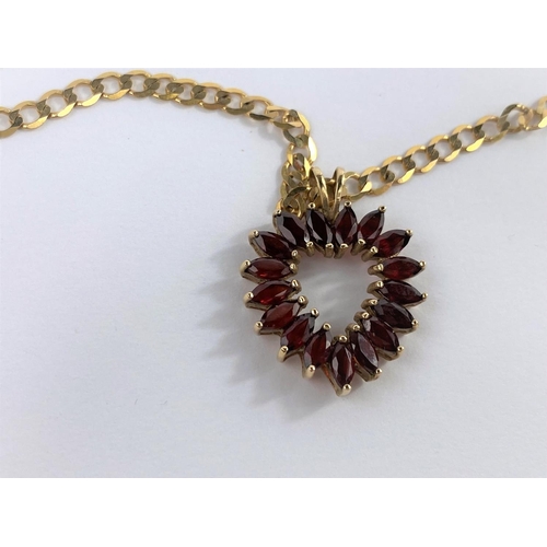 651C - A 9ct gold garnet set heart shaped pendant on a yellow metal flat link chain stamped 9kt weight 10.8... 