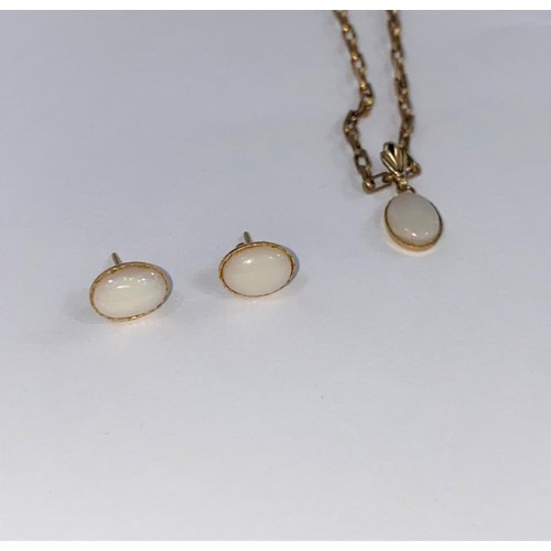 669 - An oval opal style pendant on 9 carat hallmarked gold chain (4gm) and similar earrings