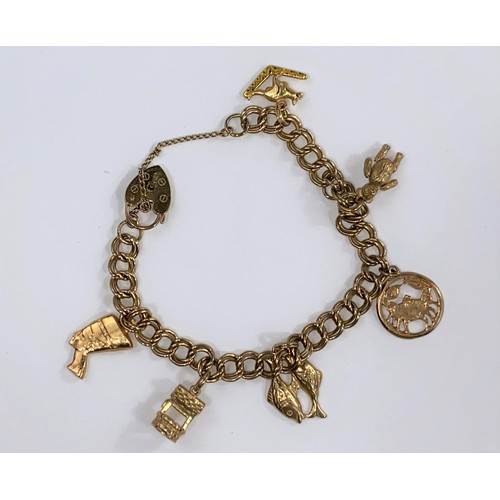 670 - A 9ct hallmarked gold charm bracelet with 6 charms, 25g (some chains unmarked)
