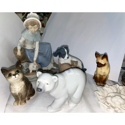 517A - A small Beswick cat, a Lladro polar bear and a selection of Nao animals etc