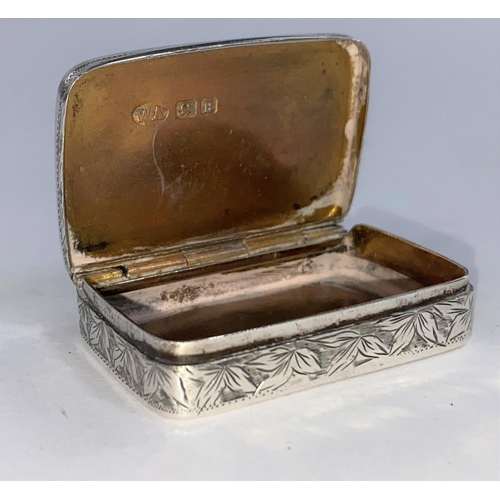 612D - A rectangular silver snuff/pill box with chased leaf decoration and shield cartouche, hinged lid, Ch... 