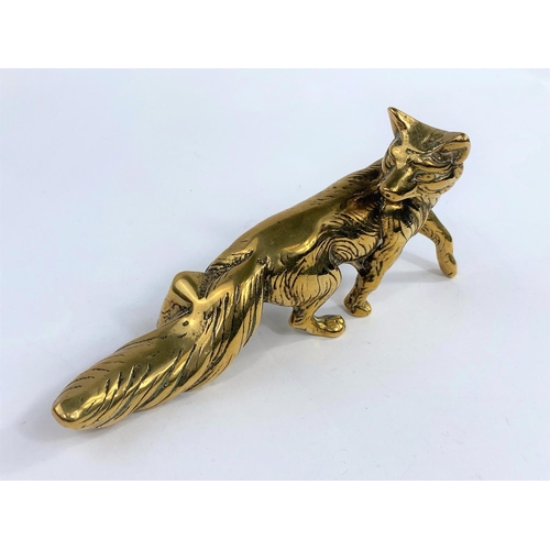 652A - A heavy brass paperweight in the form of a fox, height 21cm.