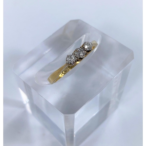 691b - A 3 stone diamond dress ring, the shank stamped 18CT PLAT, 2.1gm size M