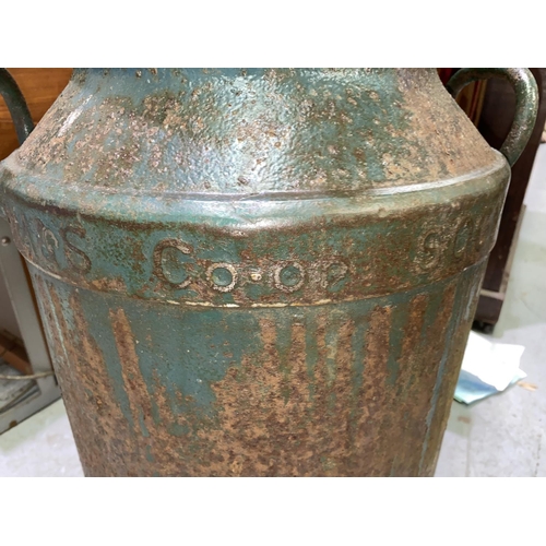 518A - A vintage cast metal Manchester Co-op society milk churn converted into planter with vintage enamel ... 