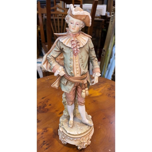 534 - A bisque figure, young man in 18th century dress, in the style of Royal Worcester
