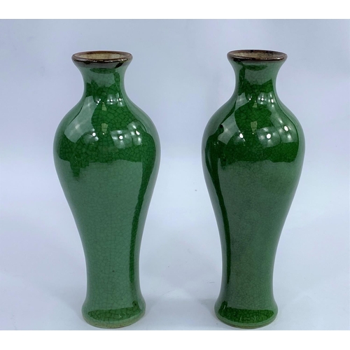 610A - A pair of Chinese monochrome green crackle glaze high
shoulder baluster vases, the rim unglazed, hei... 