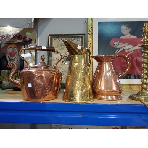11 - A copper half gallon copper conical jug, another similar 
brass and a copper tea pot