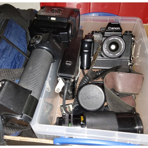 134 - A Canon F-1 SLR camera 206979 with various 
accessories and lenses, a FD 28m 1:2.8, a cannon Zoom le... 