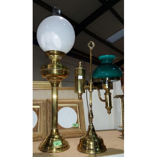 82 - A brass oil lamp on reeded column; an Edwardian style brass desk lamp with green shade