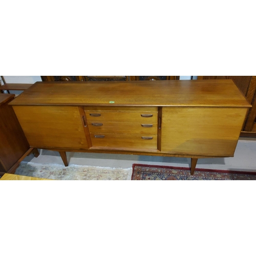 780 - A mid century long low teak sideboard with four central drawers and side cupboards and an extending ... 