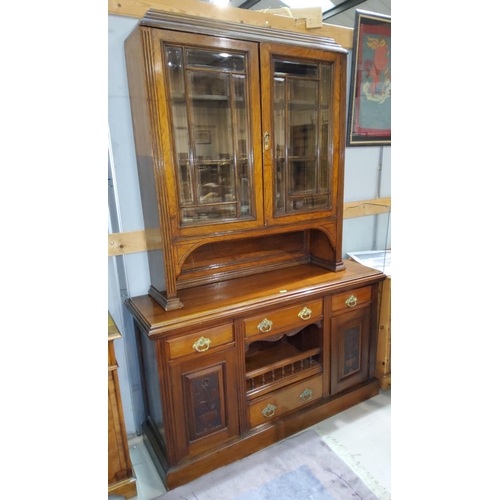 787 - An Edwardian walnut full height sideboard with carved decoration, twin glazed doors over 3 drawers, ... 