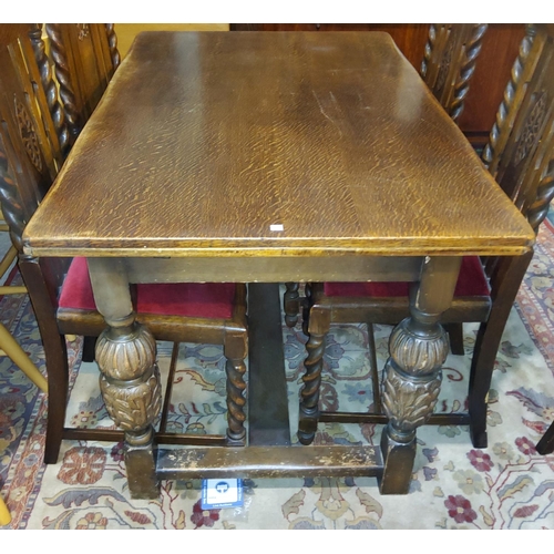 798 - An oak dining table with rectangular draw leaf top on carved bulbous legs