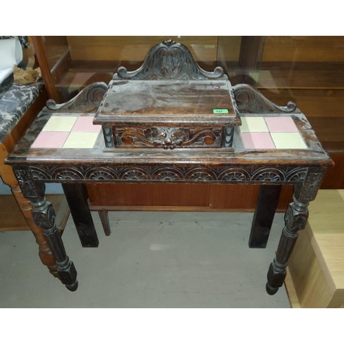 849 - A carved oak side table with single drawer to the top, with inset tiles, on tapering front legs leng... 