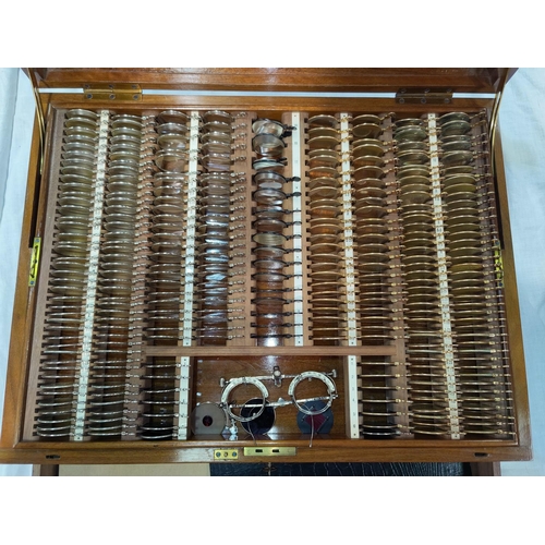 410 - A fine set of Opticians sight testing lenses, almost 300 lenses with calibrated frame in walnut case... 