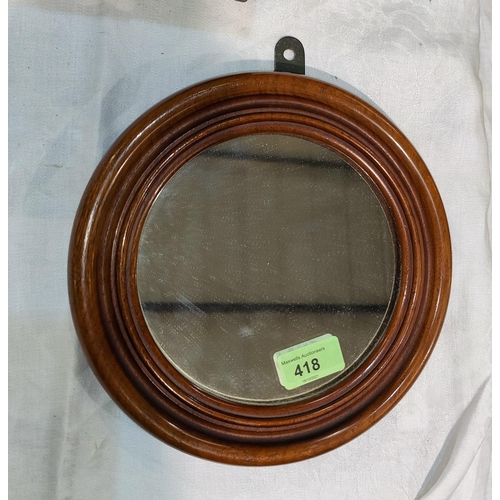 418 - A 19th century plain circular mirror in solid mahogany frame, 22cm diameter