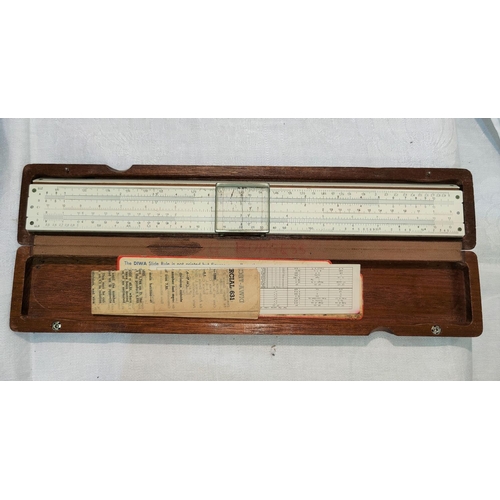 425 - A DIWA slide rule in original beechwood case, 31cm overall