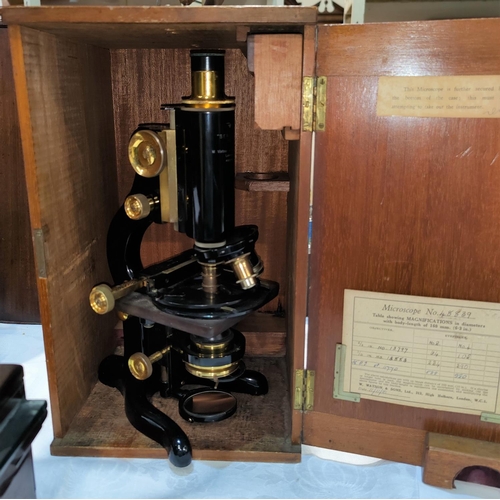 426 - A COMPOUND MICROSCOPE by W.WATSON and SONS, lacquered brass, with vernier micrometer stage, mahogany... 