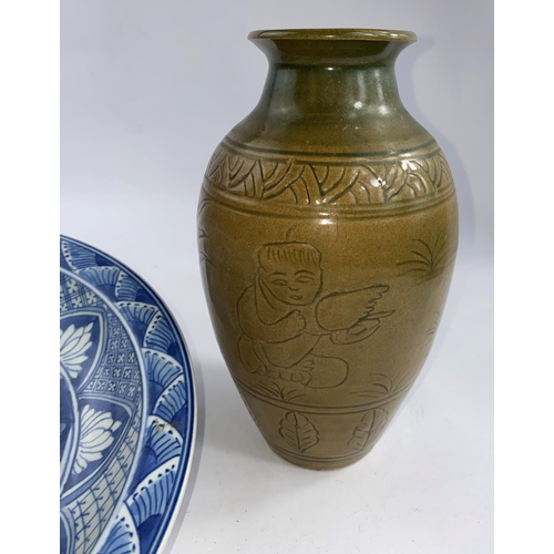 613A - A Chinese stoneware baluster vase with tea dust coloured ground with incised decoration ht 23cm; A C... 