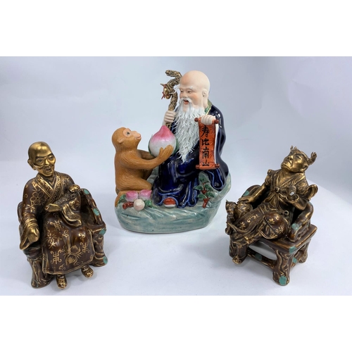 614 - 3 Chinese porcelain figures: one of a monkey giving fruit to a Sage & two others (minor chips and da... 