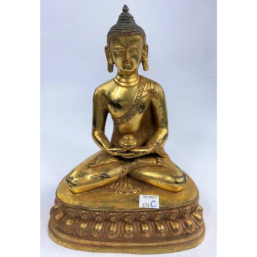 614C - A Chinese bronze gilded figure of a buddha in lotus position, ht 23cm
