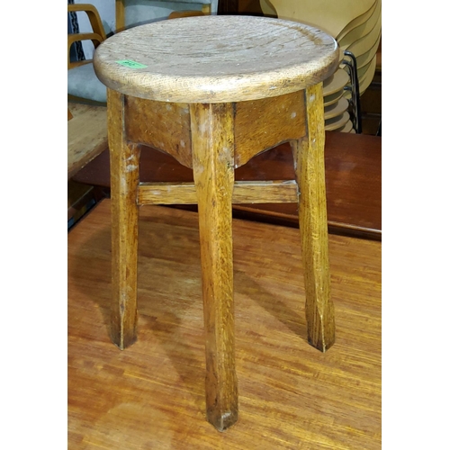 912 - An oak Arts and Crafts style circular stool with champhered legs and X-frame support