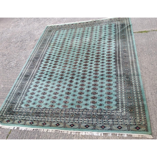 922 - A very large modern Middle Eastern elephant foot pattern carpet of green ground 360 X 281 cm