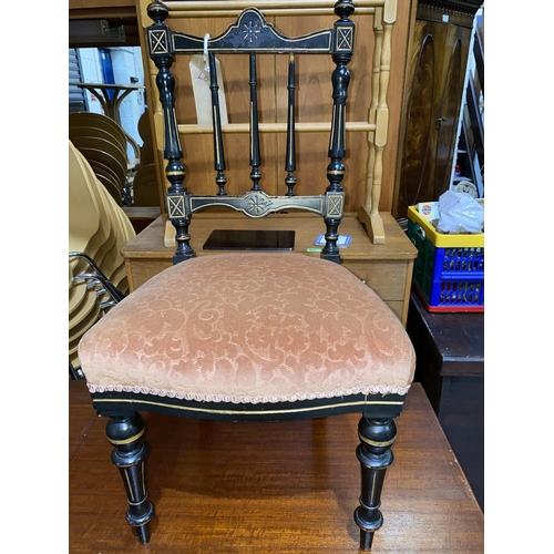 604A - A late Victorian ebonised spindle back child's chair with incised gilt decoration, turned tapering l... 