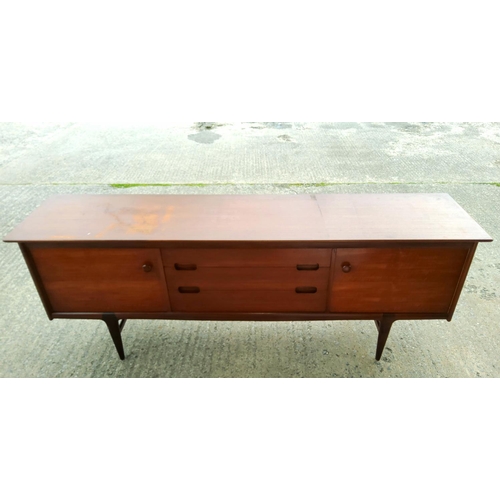 782B - A mid 20th century teak dining suite by Younger comprising a long low sideboard with two doors and t... 