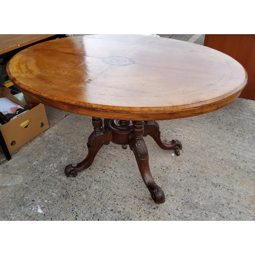 782C - A Victorian inlaid oval centre table with four columns
supports Length 120cm