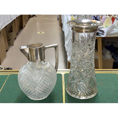 27A - A hall marked silver collar and handled cut glass claret jug and a hallmarked silver rimmed cut glas... 