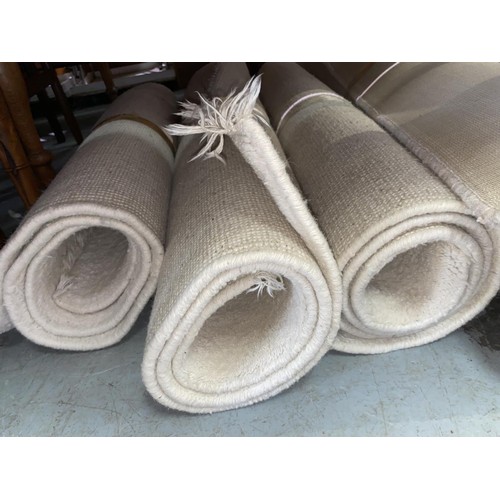 819 - Three cream coloured Indian rugs